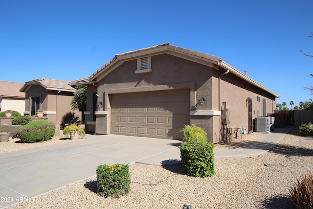 single story home with a garage and central AC