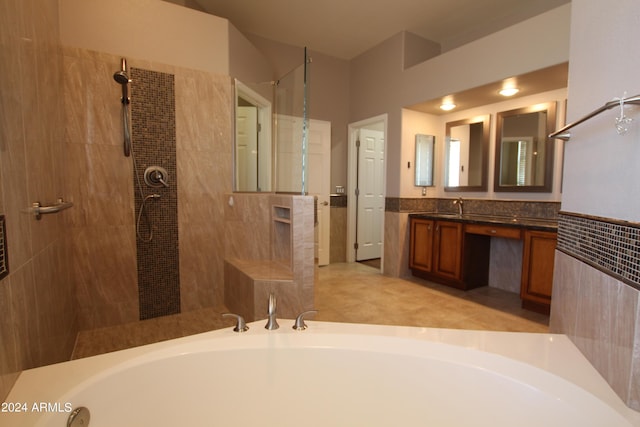 bathroom featuring vanity and shower with separate bathtub