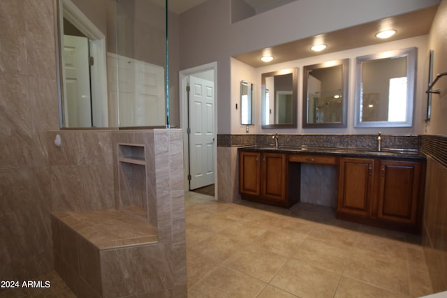 bathroom with tile patterned floors, vanity, and walk in shower