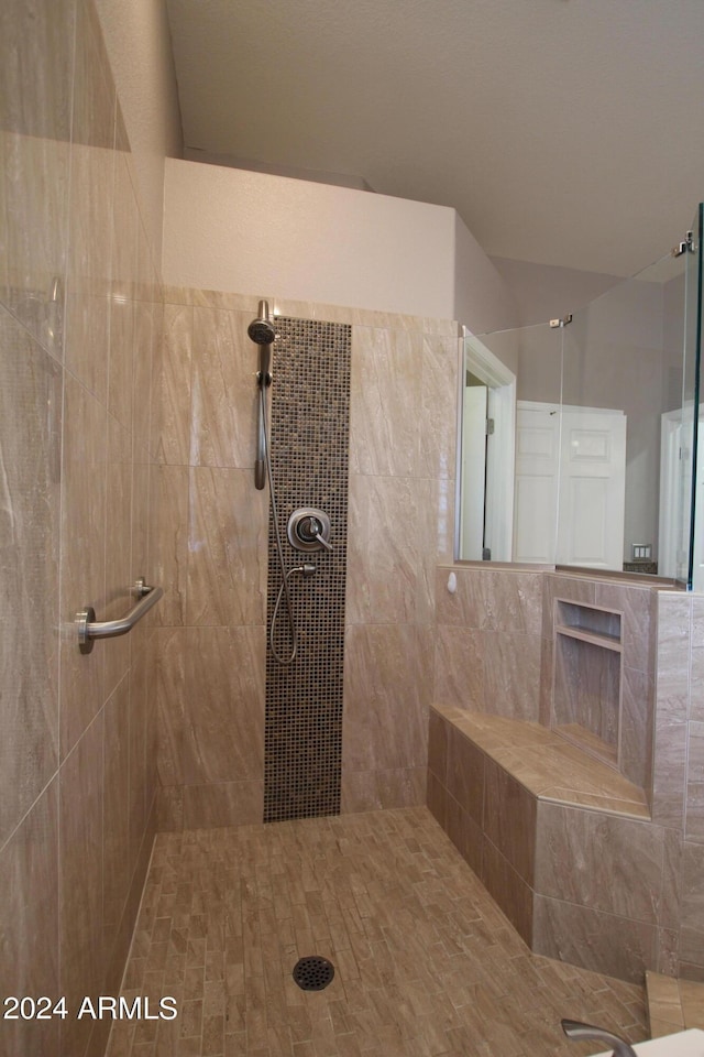 bathroom with a tile shower