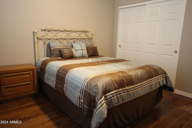 bedroom featuring a closet and dark wood-type flooring