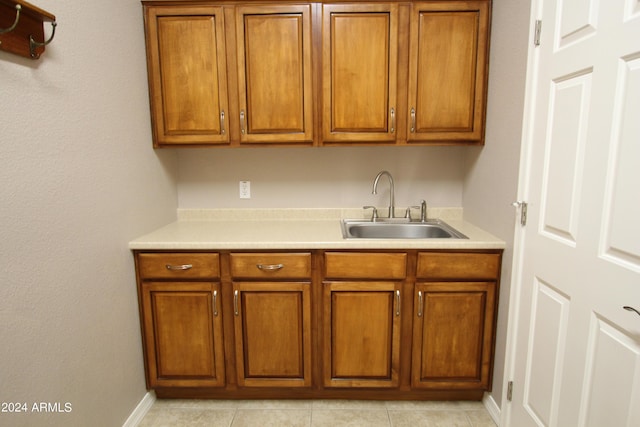 kitchen with light tile patterned flooring and sink