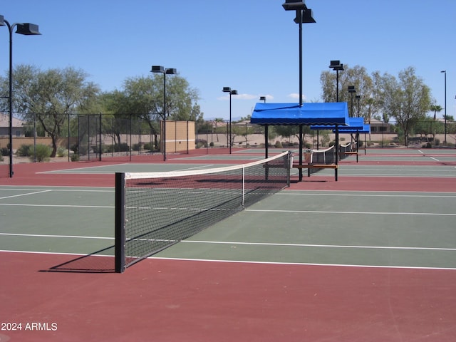 view of tennis court featuring basketball hoop