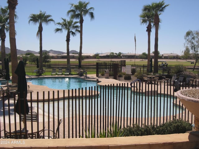 view of pool with a patio area and a mountain view