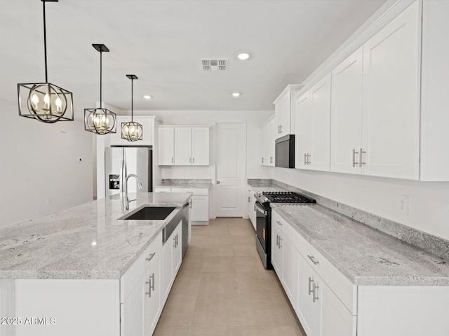 37357 W San Sisto Ave, Maricopa, AZ 85138 - kitchen featuring stainless steel appliances, white cabinets, a chandelier, recessed lighting, and pendant lighting