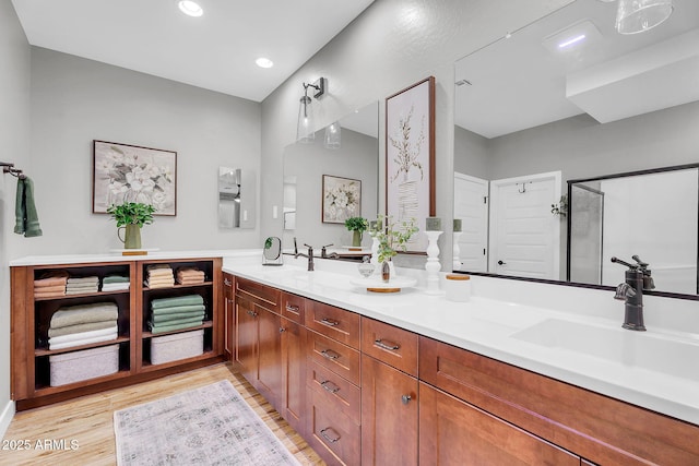 1335 W Via Del Oro, San Tan Valley, AZ 85140 - bathroom with wood finished floors, double vanity, recessed lighting, and an enclosed shower
