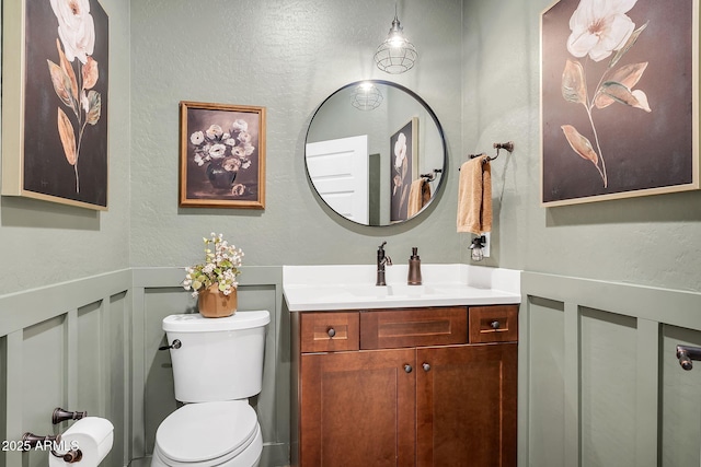 1335 W Via Del Oro, San Tan Valley, AZ 85140 - half bath with toilet, vanity, a textured wall, a wainscoted wall, and a decorative wall