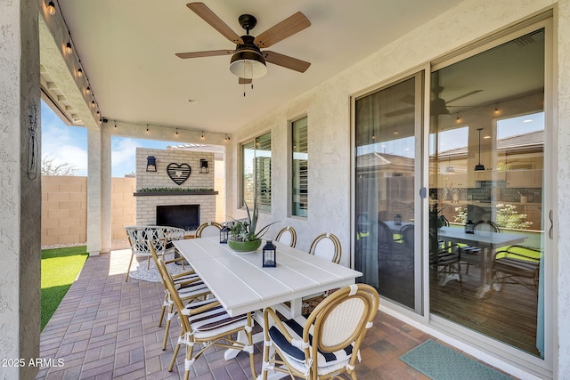 1335 W Via Del Oro, San Tan Valley, AZ 85140 - view of patio / terrace with an outdoor brick fireplace, outdoor dining space, and ceiling fan