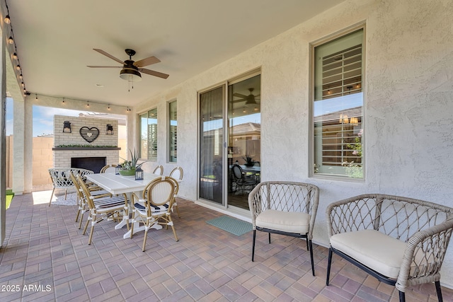 1335 W Via Del Oro, San Tan Valley, AZ 85140 - view of patio with an outdoor brick fireplace, a ceiling fan, and outdoor dining area