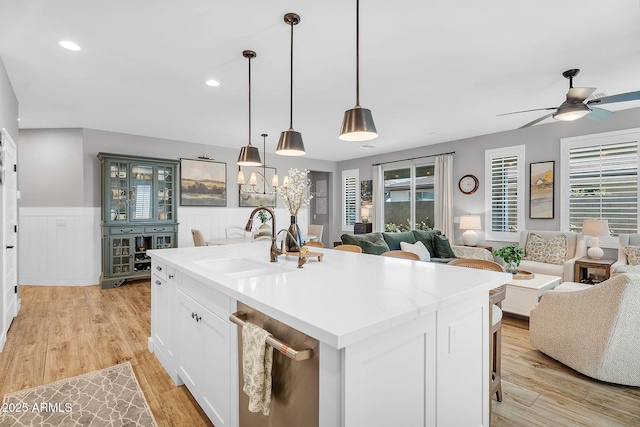 1335 W Via Del Oro, San Tan Valley, AZ 85140 - kitchen with a sink, open floor plan, ceiling fan, stainless steel dishwasher, and wainscoting