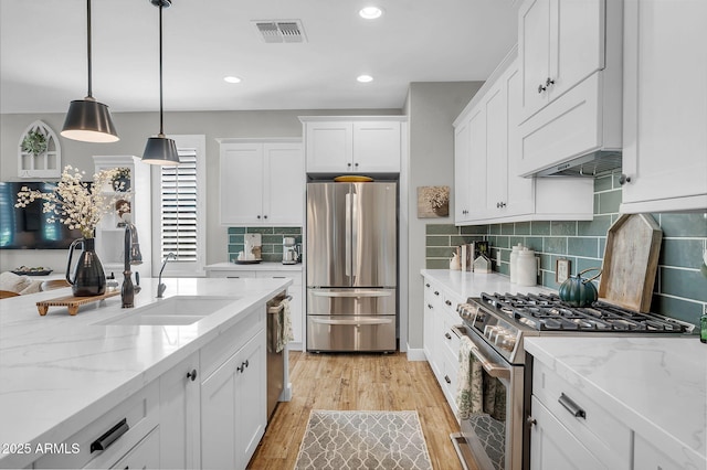 1335 W Via Del Oro, San Tan Valley, AZ 85140 - kitchen featuring stainless steel appliances, a sink, white cabinets, light wood-style floors, and recessed lighting