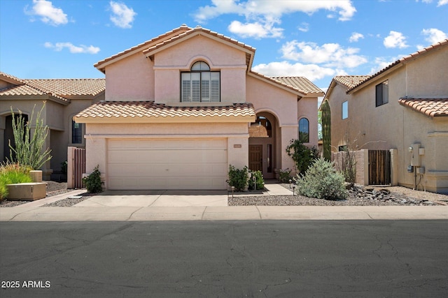 14186 N 100th Pl, Scottsdale, AZ 85260 - mediterranean / spanish-style home featuring stucco siding, concrete driveway, a tiled roof, and an attached garage