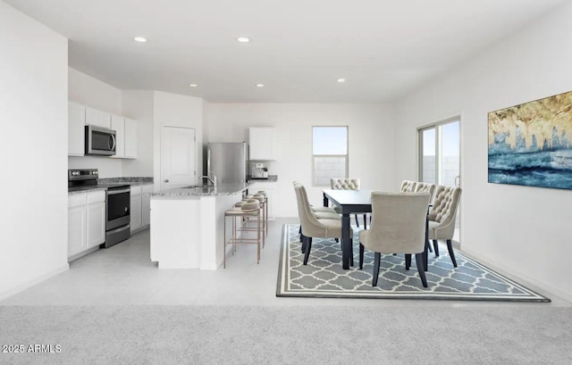 carpeted dining room featuring sink