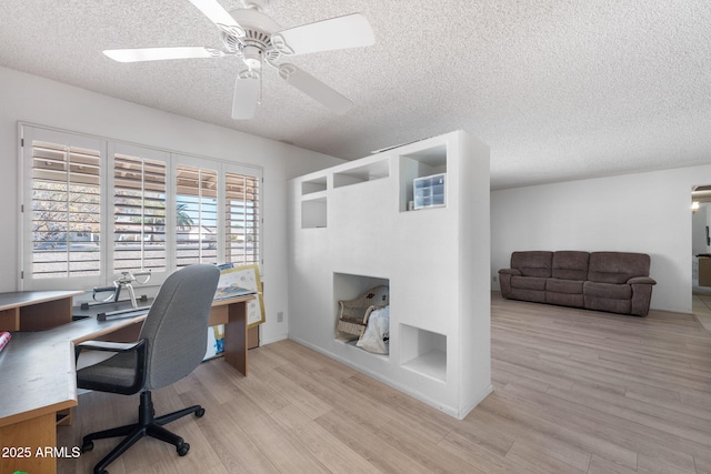 office area with light wood-type flooring, a textured ceiling, and a ceiling fan