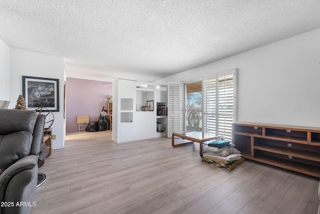 interior space with a textured ceiling and light wood finished floors