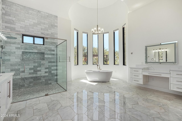 bathroom featuring a notable chandelier, vanity, shower with separate bathtub, and a high ceiling