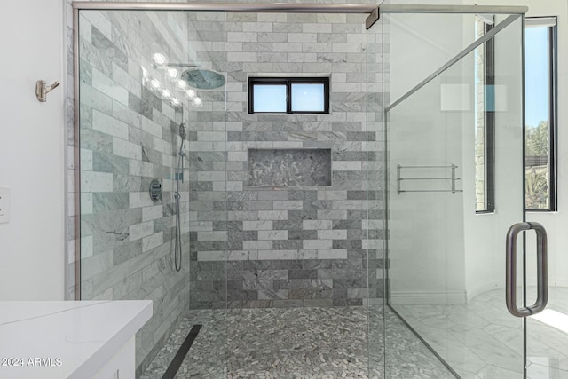 bathroom featuring plenty of natural light and a shower with shower door