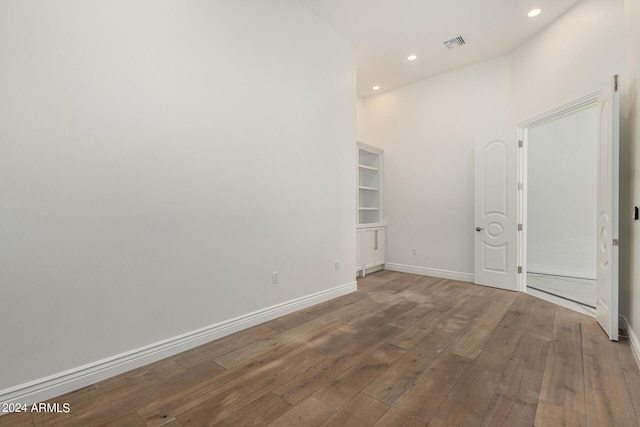 empty room with hardwood / wood-style flooring