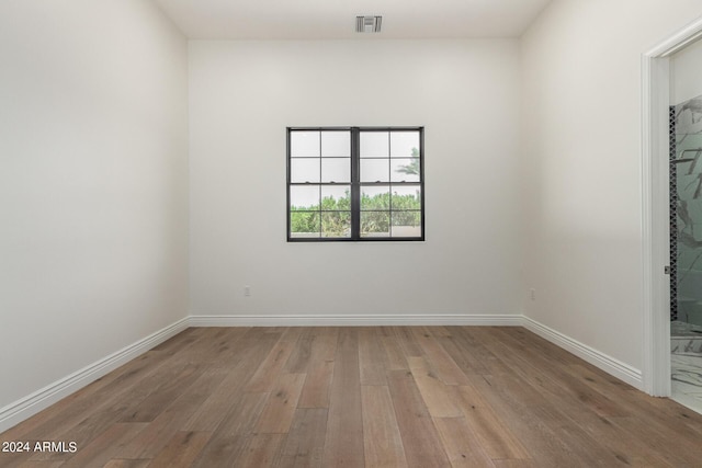 spare room featuring light hardwood / wood-style flooring