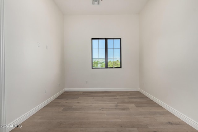 empty room with light hardwood / wood-style flooring