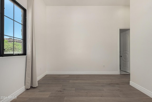 empty room with dark hardwood / wood-style floors