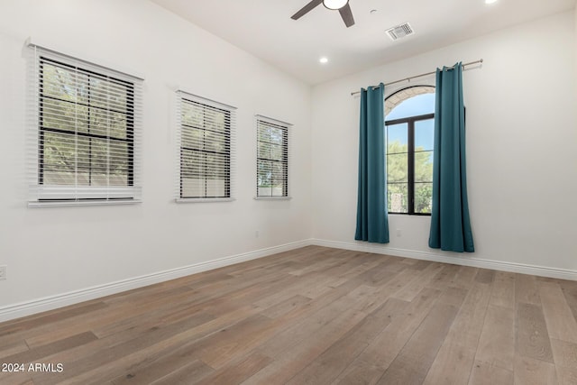 empty room with light hardwood / wood-style flooring and ceiling fan