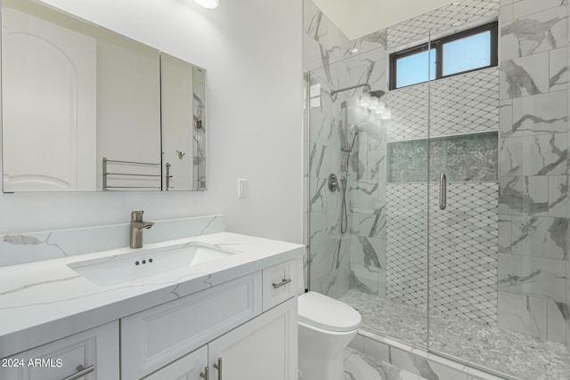 bathroom featuring toilet, an enclosed shower, and vanity