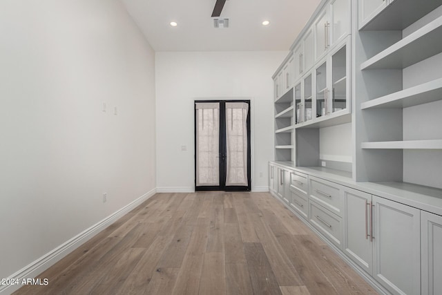 interior space with french doors and light hardwood / wood-style flooring