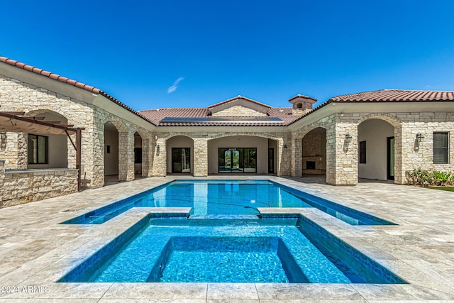 view of pool with an in ground hot tub