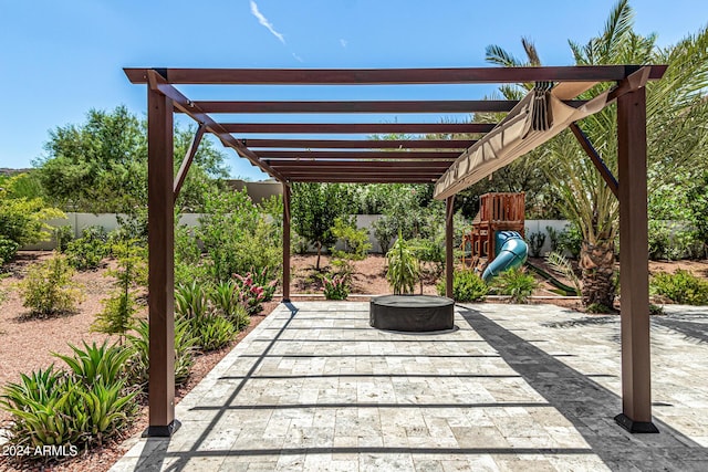 view of patio / terrace with a pergola and a playground