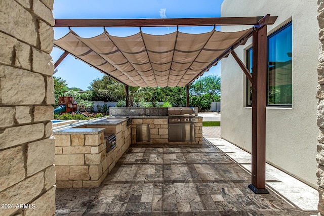 view of patio featuring a pergola, area for grilling, and sink