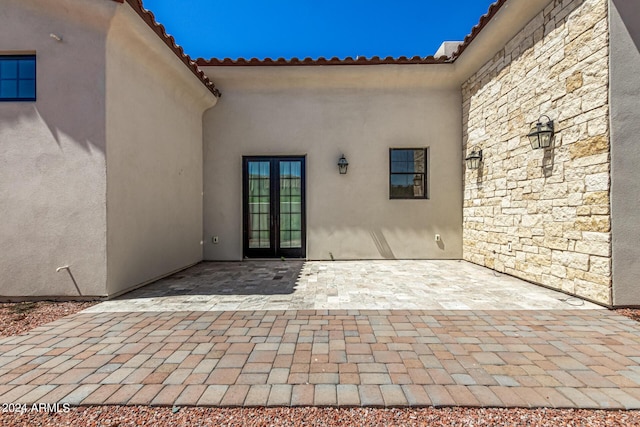 view of exterior entry featuring french doors