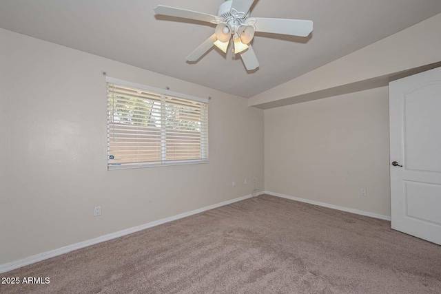 spare room with vaulted ceiling, baseboards, carpet floors, and ceiling fan