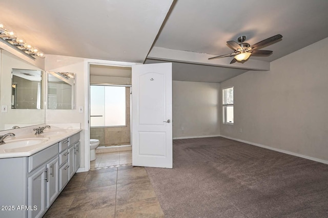 full bath with a shower stall, toilet, baseboards, and a sink