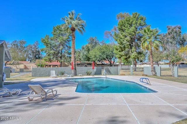 community pool featuring a patio and fence