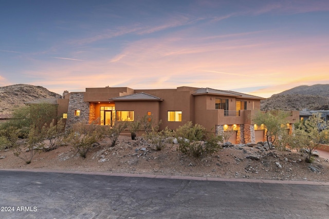 view of front of home featuring a mountain view and a balcony