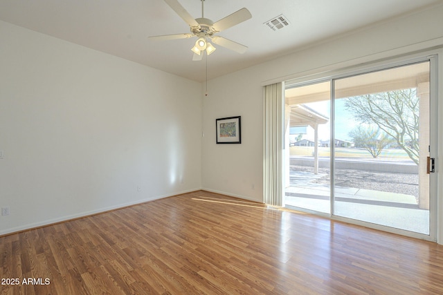 empty room with hardwood / wood-style floors and ceiling fan