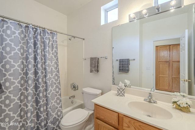 full bathroom with vanity, shower / tub combo with curtain, and toilet