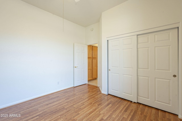 unfurnished bedroom with hardwood / wood-style flooring and a closet