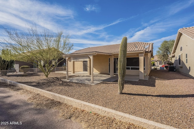 back of property with central AC and a patio area