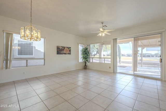 spare room featuring light tile patterned floors and ceiling fan with notable chandelier