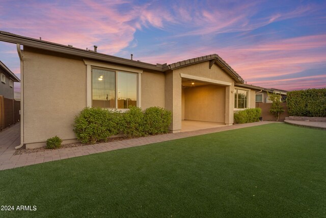 single story home featuring a patio area, stucco siding, a front yard, and fence