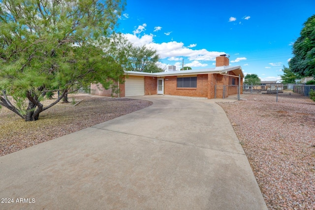 322 N Flynn Jans Ct, Pearce, AZ 85625 - ranch-style house featuring driveway, brick siding, a chimney, fence, and an attached garage