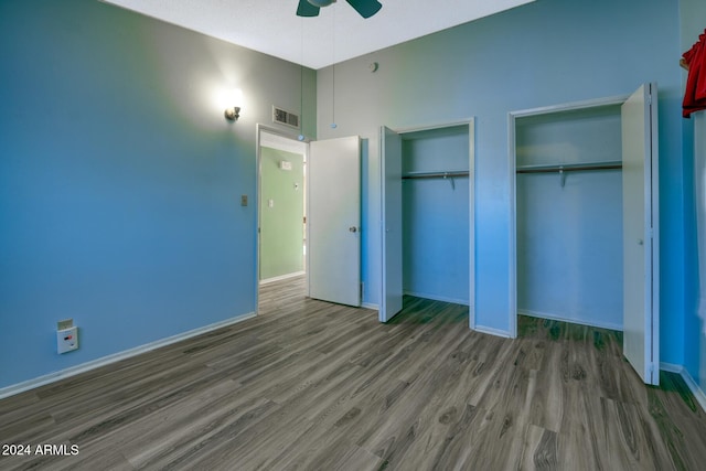 322 N Flynn Jans Ct, Pearce, AZ 85625 - unfurnished bedroom featuring multiple closets, wood finished floors, baseboards, and ceiling fan