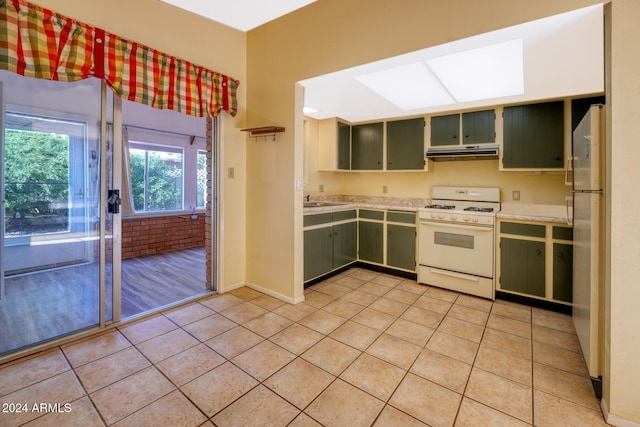 322 N Flynn Jans Ct, Pearce, AZ 85625 - kitchen featuring white appliances, green cabinets, under cabinet range hood, and light countertops