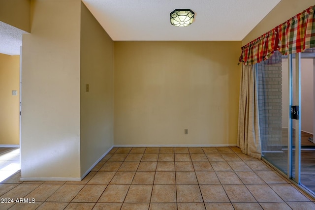 322 N Flynn Jans Ct, Pearce, AZ 85625 - spare room featuring light tile patterned flooring, baseboards, and a textured ceiling