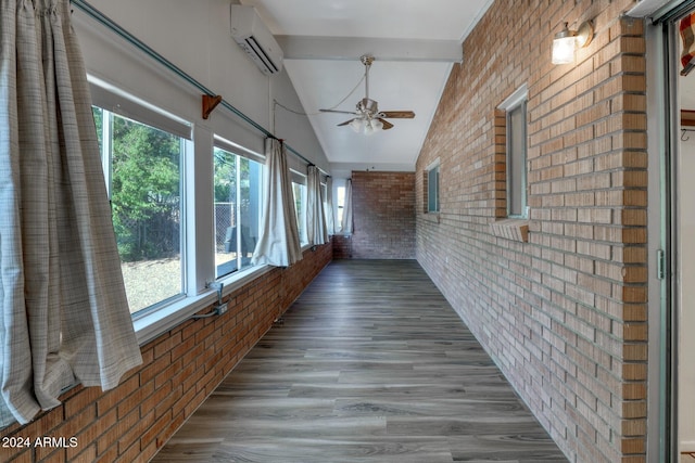 322 N Flynn Jans Ct, Pearce, AZ 85625 - hall with brick wall, a wall mounted air conditioner, and wood finished floors