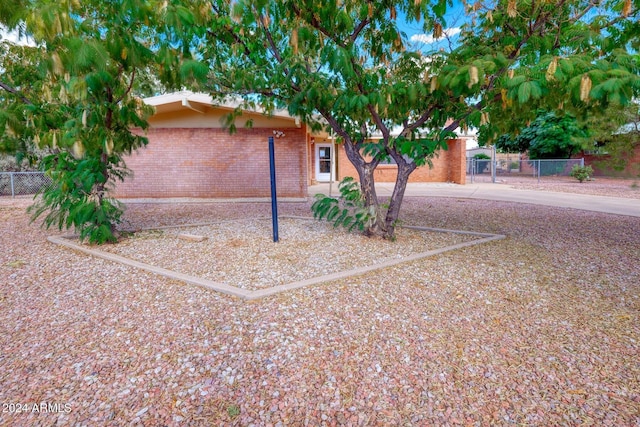 322 N Flynn Jans Ct, Pearce, AZ 85625 - view of property exterior with fence, brick siding, and concrete driveway