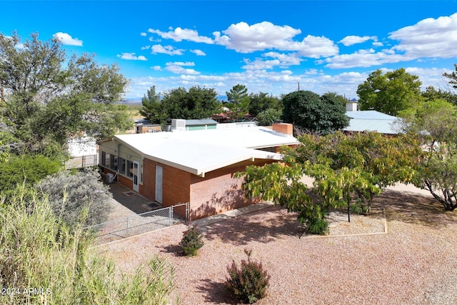 322 N Flynn Jans Ct, Pearce, AZ 85625 - back of house with fence, brick siding, and a chimney