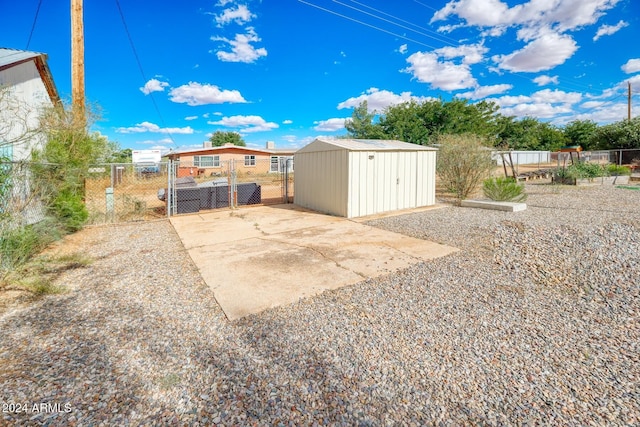 322 N Flynn Jans Ct, Pearce, AZ 85625 - view of patio featuring a storage shed, fence, an outdoor structure, and a gate